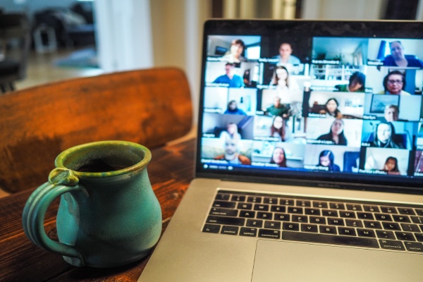 Work colleagues on Zoom call on laptop in a home office